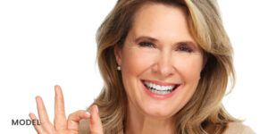Older Female Displaying Dental Implants with Smile